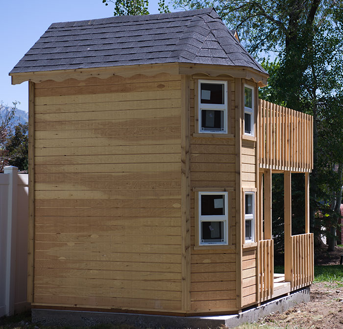 Image of backside of wood playhouse