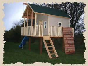 Wooden outdoor playhouse for backyard with swing and rock climbing wall